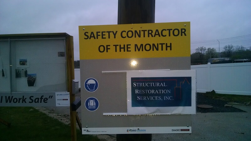 Sign recognizing Structural Restoration Services, Inc as the safety contractor of the month