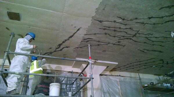 Structural repair being performed on the interior ceiling of a building